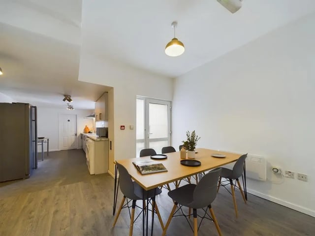 Dining table chairs kitchen with appliances communal area at 7 Bedroom House at 6, KIPPAX STREET in Manchester Student Accommodation