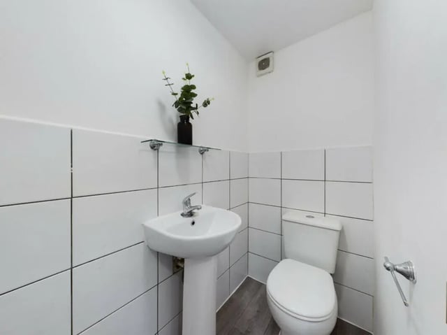 White sink toilet tiled walls and plant bathroom Image at 4 Bedroom House at Flat 1 30, Haydn Avenue in Manchester Student Accommodation