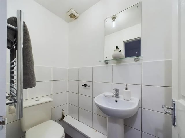 Toilet sink towel rack and mirror bathroom at 4 Bedroom House at Flat 1, 58, Ruskin Avenue in Manchester Student Accommodation