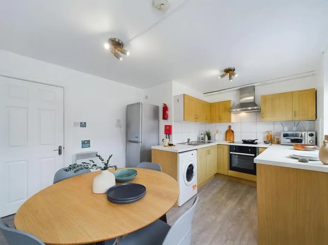 Kitchen with dining table and appliances kitchen at 4 Bedroom House at Flat 1, 58, Ruskin Avenue in Manchester Student Accommodation