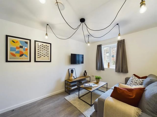 Sofa coffee table artwork and television living room at 4 Bedroom House at Flat 1, 58, Ruskin Avenue in Manchester Student Accommodation