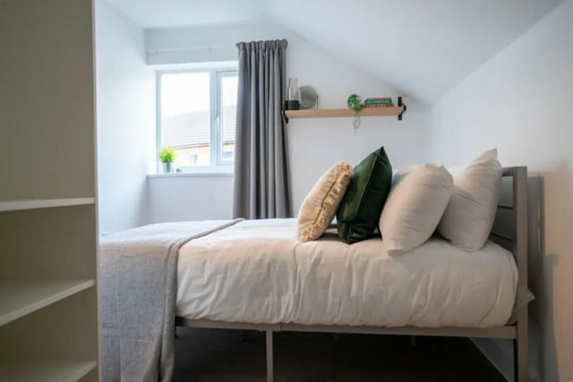 Bed with pillows grey throw window Bedroom at 6 Bedroom House at 5, ASHFIELD ROAD in Manchester Student Accommodation
