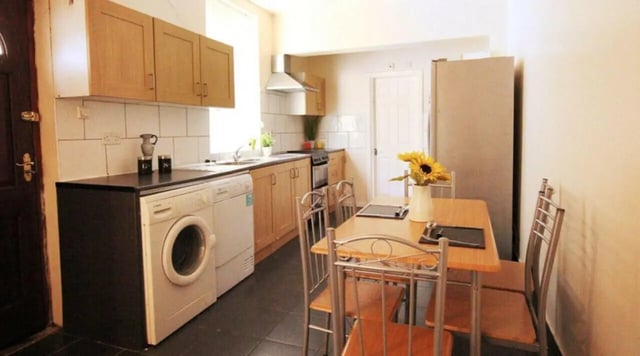 Washing machine counter cabinets dining table kitchen at 6 Bedroom House at 5, ASHFIELD ROAD in Manchester Student Accommodation