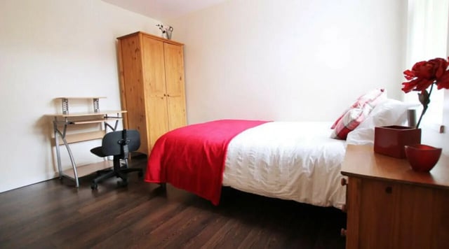 Bed desk wardrobe wooden floor bedroom at 6 Bedroom House at 5, ASHFIELD ROAD in Manchester Student Accommodation