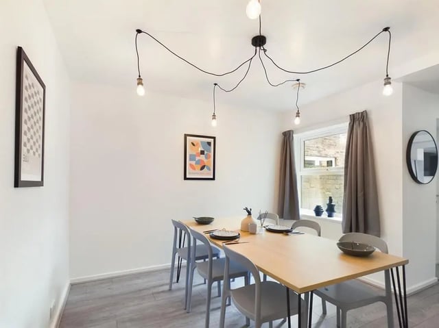 Dining table with chairs framed art lights Dining room at 6 Bedroom House at 174, ACOMB STREET in Manchester Student Accommodation