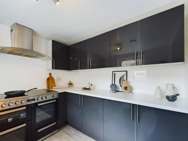 Modern kitchen with dark cabinets and steel appliances kitchen at 6 Bedroom House at 174, ACOMB STREET in Manchester Student Accommodation