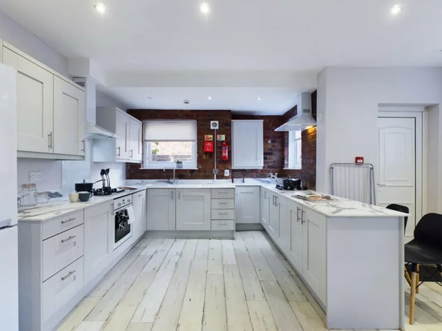 White cabinets marble countertops stove and sink kitchen at 8 Bedroom House at 211, Molyneux Road in Liverpool Student Accommodation