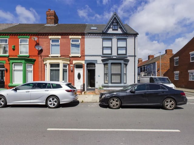 Two cars parked outside residential terraced houses exterior at 8 Bedroom House at 211, Molyneux Road in Liverpool Student Accommodation