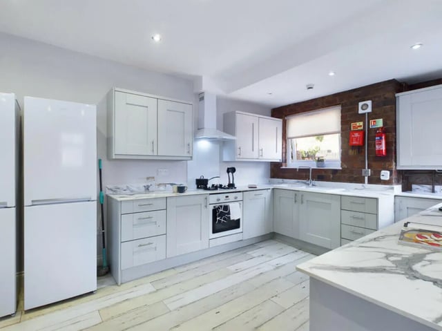 White refrigerators stove cabinets sink kitchen at 8 Bedroom House at 211, Molyneux Road in Liverpool Student Accommodation