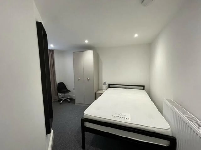Bed closet chair nightstand radiator bedroom at 2 Bedroom House at 20 E, Portland Street in Lincoln Student Accommodation