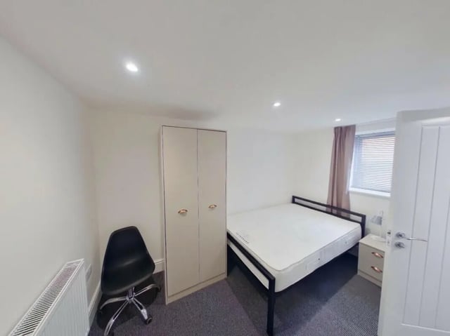 Bed wardrobe chair radiator bedside table bedroom at 2 Bedroom House at 20 E, Portland Street in Lincoln Student Accommodation