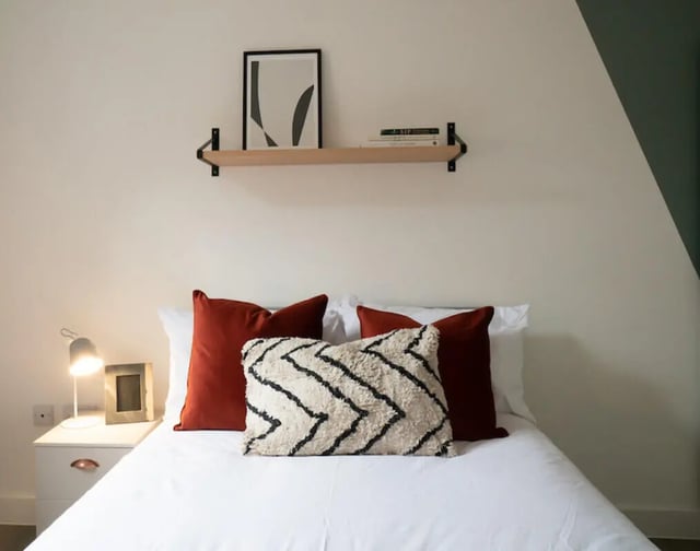 Bed with pillows lamp and art bedroom at 5 Bedroom House at 38, Cavendish Street in Lancaster Student Accommodation