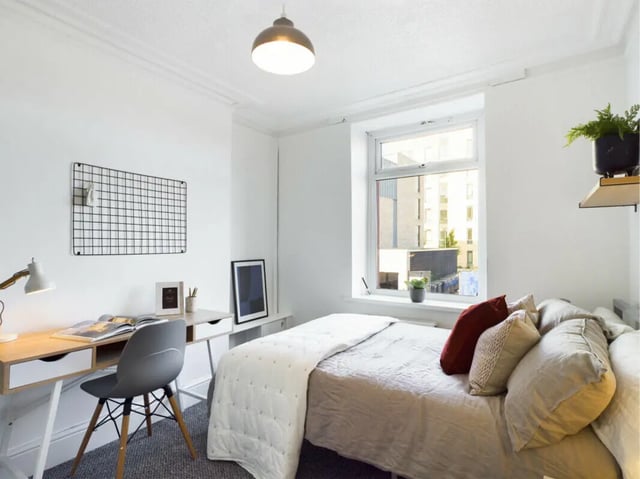 Desk bed plant and grid wall bedroom at 5 Bedroom House at 17, Gladstone Terrace in Lancaster Student Accommodation