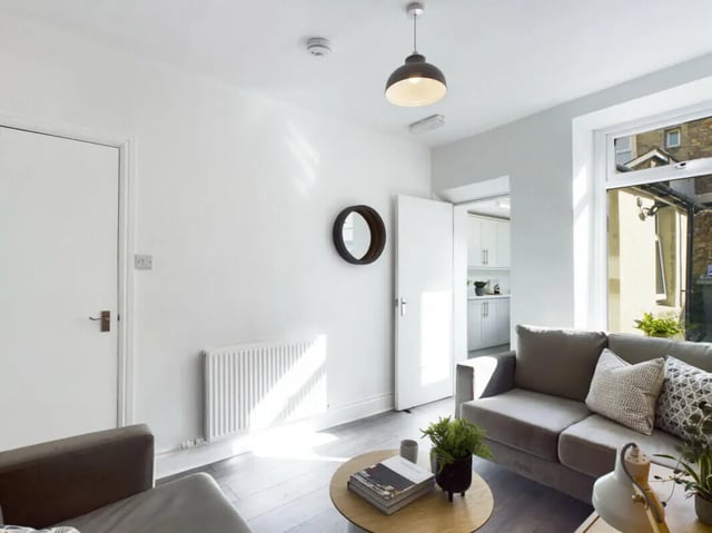 Modern living room with sofa coffee table and kitchen living room at 5 Bedroom House at 17, Gladstone Terrace in Lancaster Student Accommodation