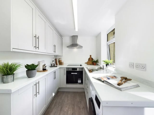 White cabinets oven sink and houseplants kitchen at 5 Bedroom House at 17, Gladstone Terrace in Lancaster Student Accommodation