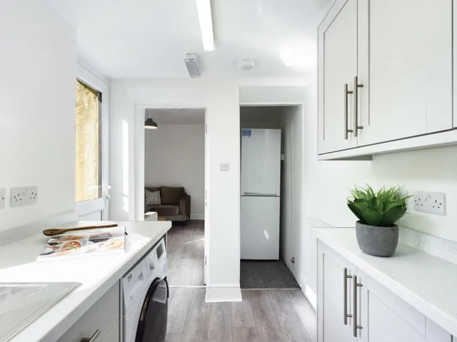 Washer refrigerator sofa and cabinets kitchen at 5 Bedroom House at 17, Gladstone Terrace in Lancaster Student Accommodation