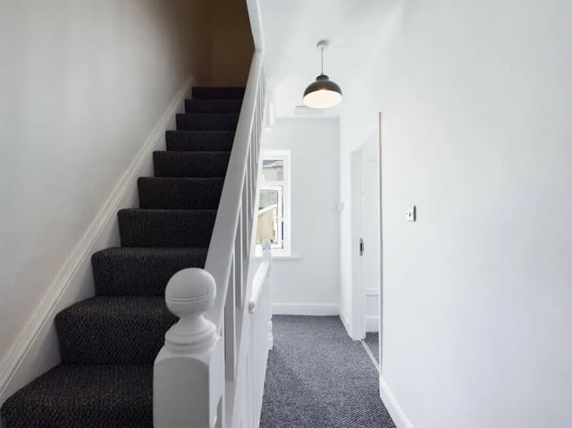 Carpeted stairs white banister hallway leading to doors hallway at 5 Bedroom House at 17, Gladstone Terrace in Lancaster Student Accommodation