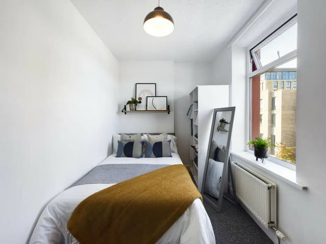 Bed with art shelf and mirror bedroom at 5 Bedroom House at 17, Gladstone Terrace in Lancaster Student Accommodation