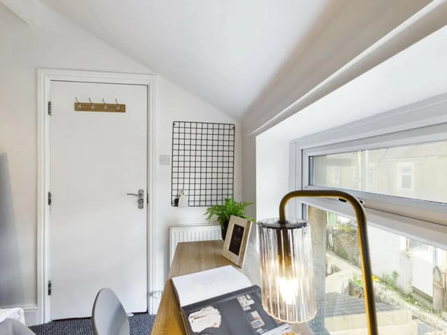 Desk with lamp plant and book study area at 5 Bedroom House at 17, Gladstone Terrace in Lancaster Student Accommodation