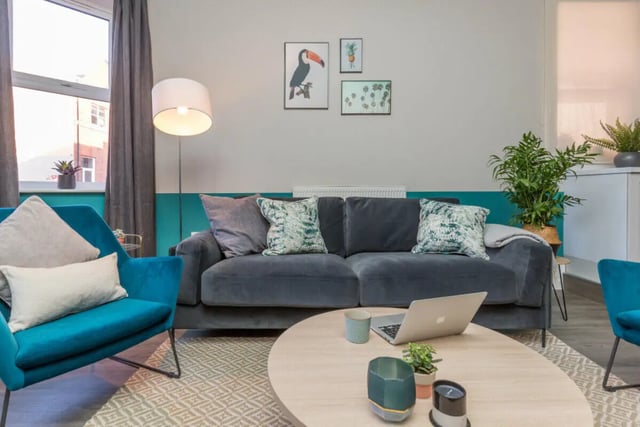 Sofa armchair coffee table laptop living room at 5 Bedroom House at 64, Monson Street in Lincoln Student Accommodation