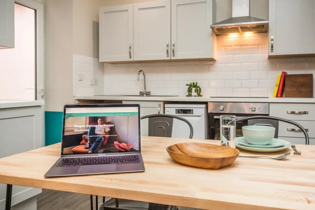 Laptop dishes on table modern kitchen kitchen at 5 Bedroom House at 64, Monson Street in Lincoln Student Accommodation