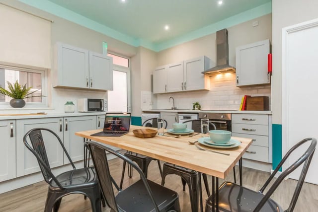 Dining table chairs laptop microwave oven kitchen at 5 Bedroom House at 64, Monson Street in Lincoln Student Accommodation