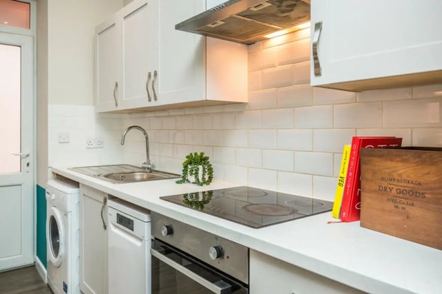White cabinets sink stove and washing machine kitchen at 5 Bedroom House at 64, Monson Street in Lincoln Student Accommodation