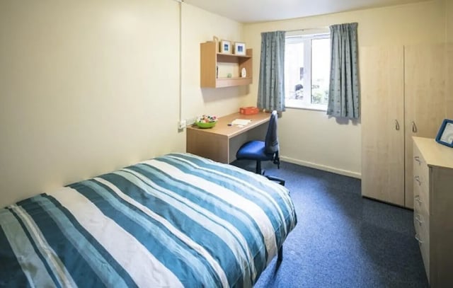 Bed desk chair wardrobe and chest of drawers bedroom at 4 Bedroom House at 13, Brookside in Derby Student Accommodation