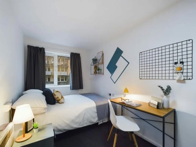 Bed desk chair and wall grid bedroom at 4 Bedroom House at 17, Brookside in Derby Student Accommodation