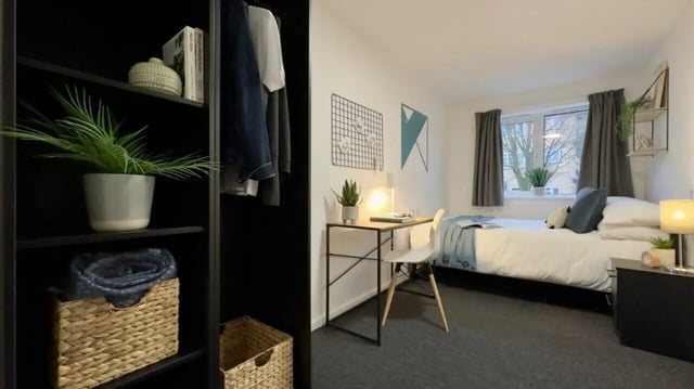 Bed desk plant and wardrobe student bedroom at 4 Bedroom House at 17, Brookside in Derby Student Accommodation