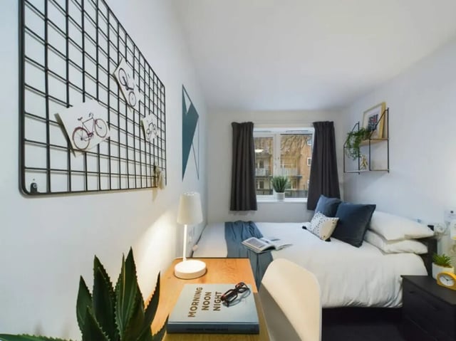 Desk plant lamp bed with pillows and window bedroom at 4 Bedroom House at 17, Brookside in Derby Student Accommodation