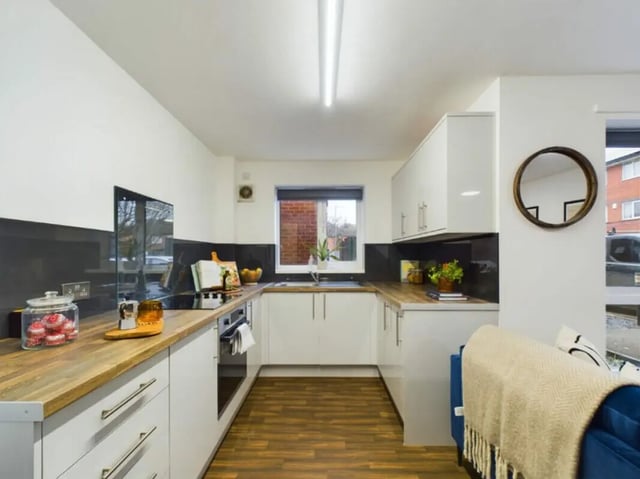 Modern kitchen with white cabinets and wooden counters kitchen at 4 Bedroom House at 17, Brookside in Derby Student Accommodation