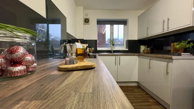 Cupboard and counter with coffee maker kitchen at 4 Bedroom House at 17, Brookside in Derby Student Accommodation