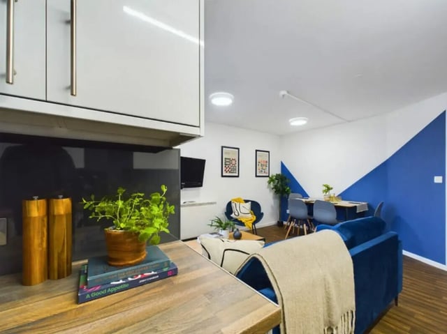Kitchen dining living area with blue sofa living room at 4 Bedroom House at 17, Brookside in Derby Student Accommodation