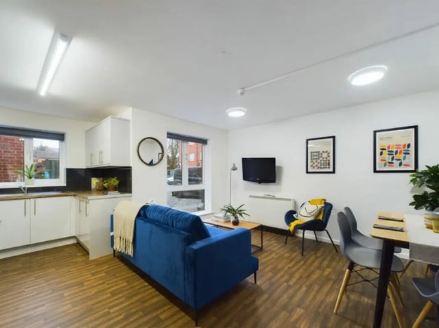 Blue sofa kitchen and dining living room at 4 Bedroom House at 17, Brookside in Derby Student Accommodation