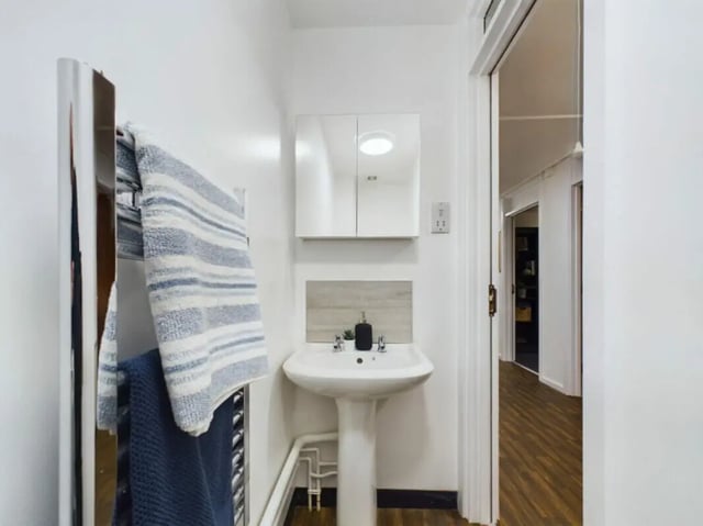 Pedestal sink medicine cabinet towels towel rack bathroom at 4 Bedroom House at 17, Brookside in Derby Student Accommodation
