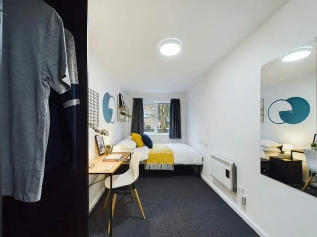 Bed desk chair mirror and closet student bedroom at 4 Bedroom House at 17, Brookside in Derby Student Accommodation