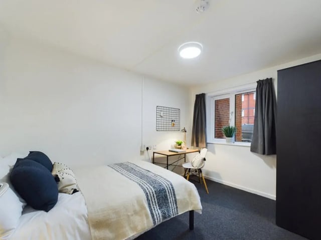 Bed desk chair wardrobe and window bedroom at 3 Bedroom House at 20, Brookside in Derby Student Accommodation