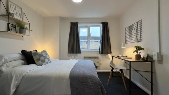 Bed desk shelves plant window bedroom at 3 Bedroom House at 20, Brookside in Derby Student Accommodation