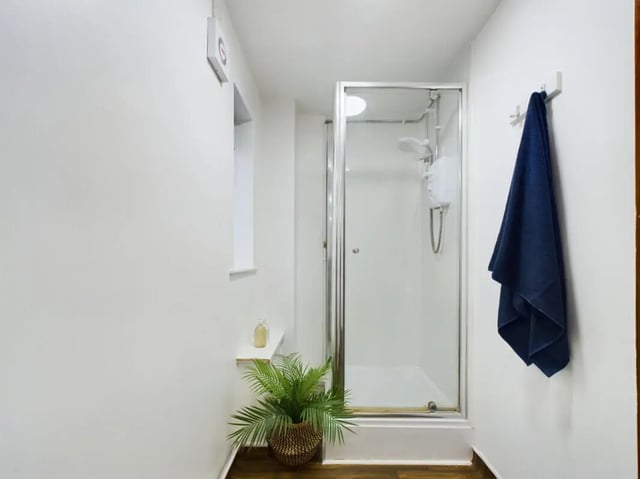 Shower stall with blue towel plant Bathroom at 3 Bedroom House at 20, Brookside in Derby Student Accommodation