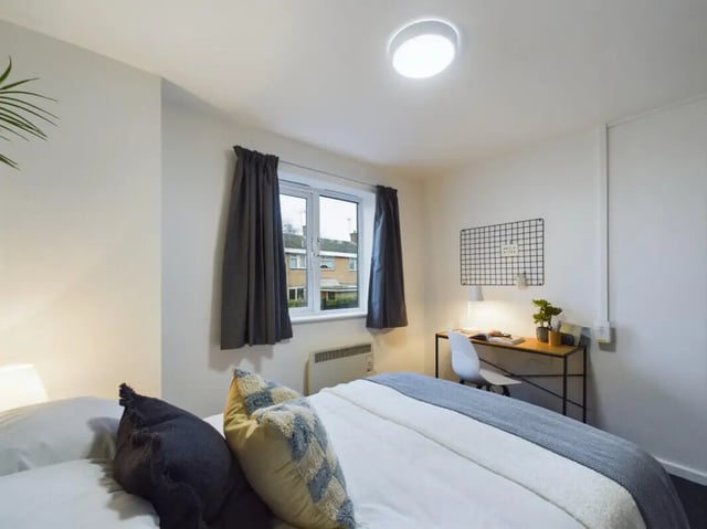 Bed desk window radiator and plant bedroom at 3 Bedroom House at 20, Brookside in Derby Student Accommodation