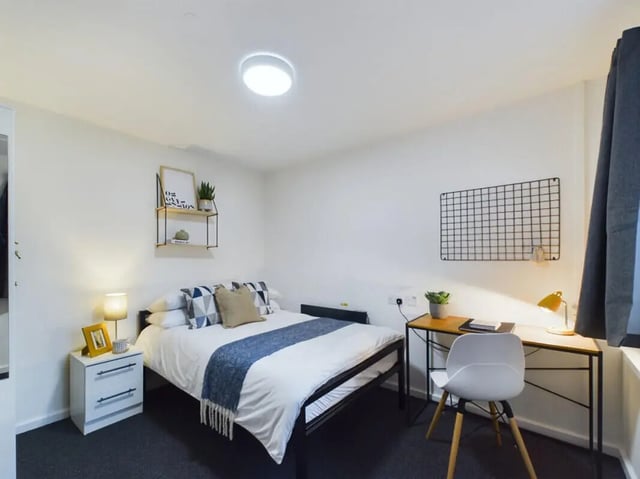 Bed desk chair and nightstand bedroom at 3 Bedroom House at 20, Brookside in Derby Student Accommodation