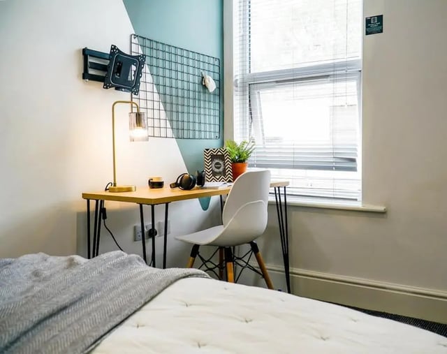Desk lamp chair grid and bed bedroom study area at 6 Bedroom House at 23, Haydn Avenue in Manchester Student Accommodation