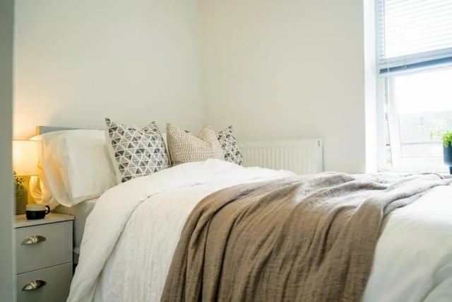 Bed with patterned pillows and a brown throw Bedroom at 6 Bedroom House at 23, Haydn Avenue in Manchester Student Accommodation