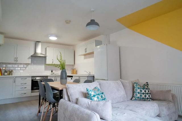 Sofa dining table chairs kitchen cabinets refrigerator living room at 5 Bedroom House at 64C, Monson Street in Lincoln Student Accommodation