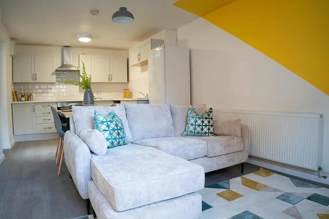 Light grey sectional couch kitchen and dining living room at 5 Bedroom House at 64C, Monson Street in Lincoln Student Accommodation