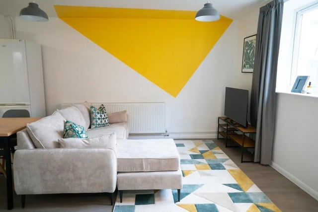 Sofa with cushions rug and TV living room at 5 Bedroom House at 64C, Monson Street in Lincoln Student Accommodation
