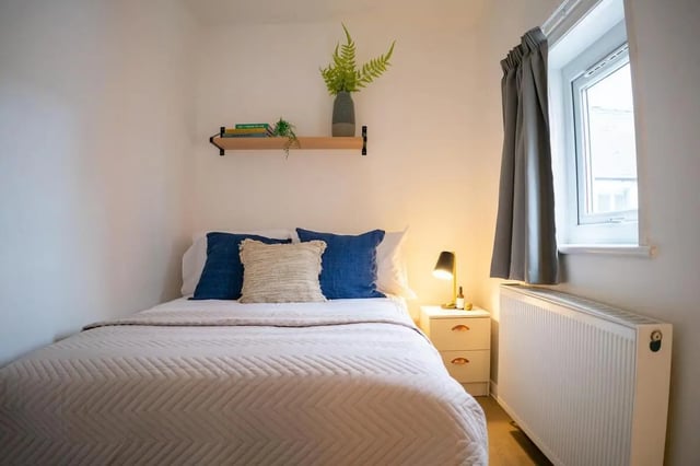 Bed with blue pillows bedside lamp nightstand bedroom at 5 Bedroom House at 64C, Monson Street in Lincoln Student Accommodation
