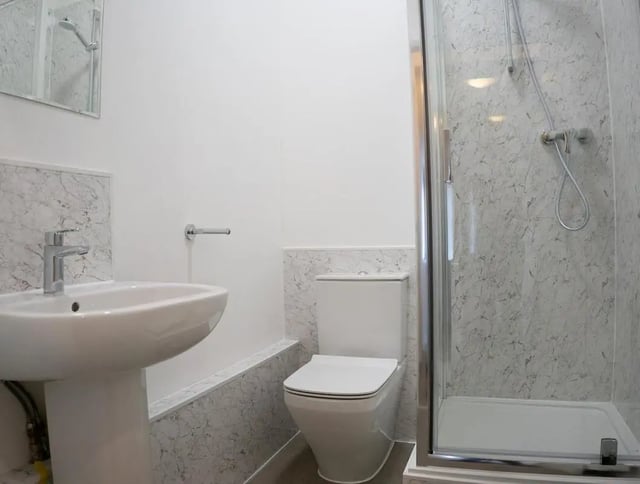 Sink toilet and shower with marble effect bathroom at 5 Bedroom House at 64C, Monson Street in Lincoln Student Accommodation