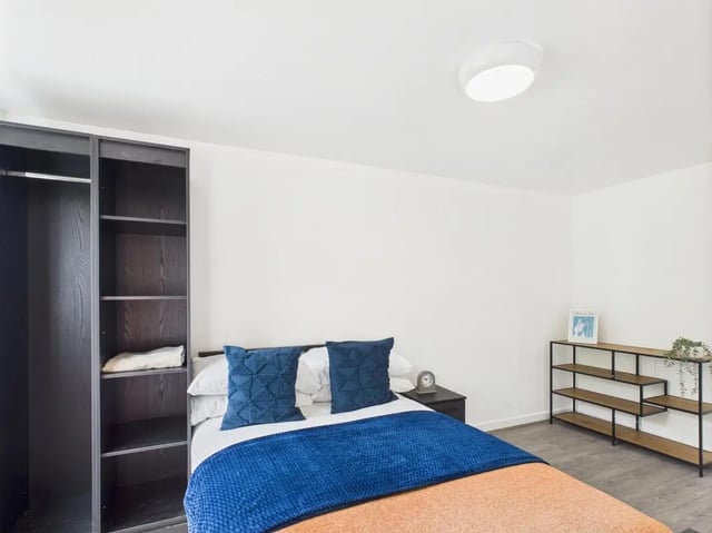 Dark wardrobe bed with blue pillows and shelf bedroom at 1 Bedroom House at Flat 21, Grove Street Studios, The Groves in Liverpool Student Accommodation